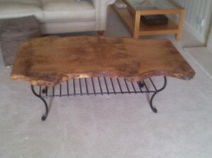 Solid oak coffee table with wrought iron magazine rack/shelf